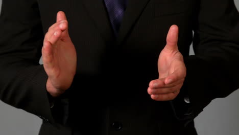 Businessman-in-suit-clapping-hands