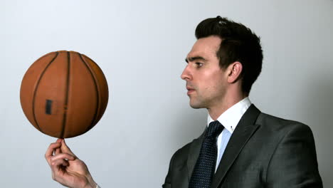 Businessman-spinning-basketball-on-finger