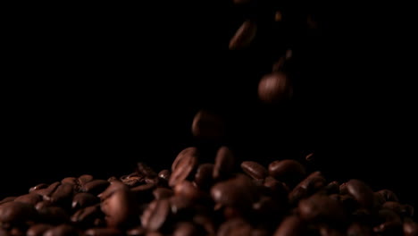 Coffee-beans-pouring-onto-pile