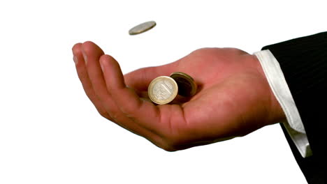 Businessman-catching-falling-coins-in-hand