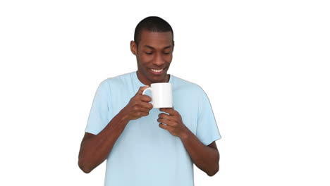 Casual-young-man-enjoying-cup-of-coffee