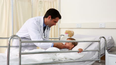 Handsome-doctor-checking-on-little-girl