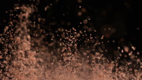 Brown-flour-bouncing-against-black-background