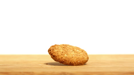 Biscuit-spinning-on-wooden-table