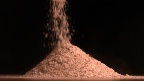 Flour-pouring-on-black-background