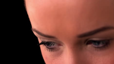Close-up-of-womans-eyes-on-black-background