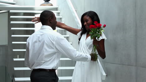 Man-giving-his-beautiful-girlfriend-red-roses