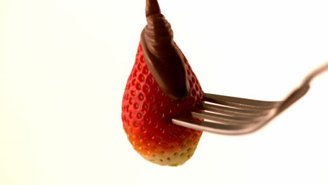 Chocolate-sauce-pouring-over-strawberry