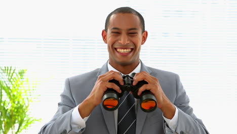 Curious-businessman-looking-through-binoculars-