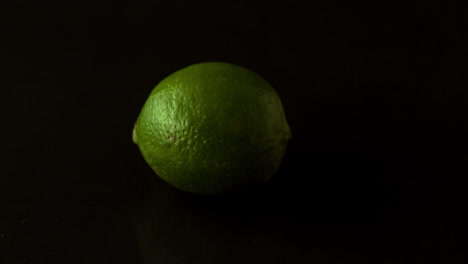 Lime-spinning-on-black-surface