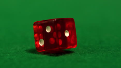 Red-dice-spinning-on-casino-table