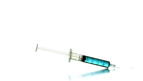 Syringe-with-blue-liquid-falling