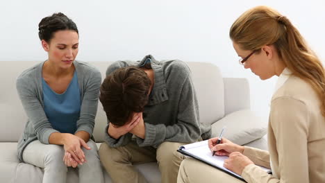 Young-unhappy-couple-talking-with-their-therapist