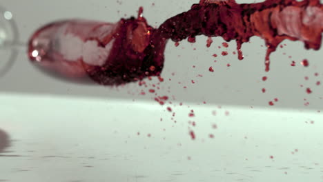 Glass-of-red-wine-falling-and-spilling