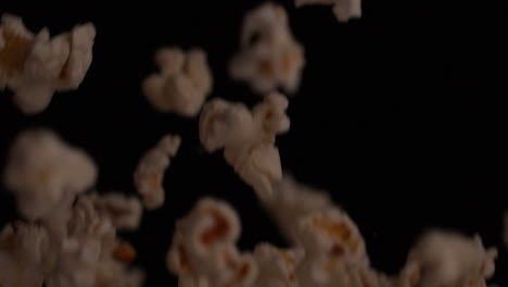 Popcorn-bouncing-against-black-background