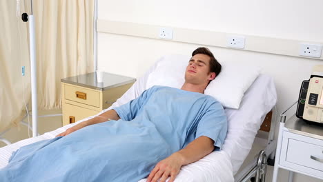 Sick-man-lying-on-hospital-bed