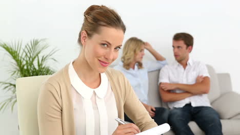 Couple-talking-on-couch-behind-their-therapist