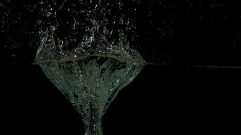 Apple-plunging-into-water-on-black-background