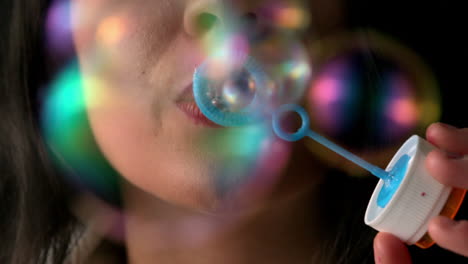 Woman-blowing-bubbles-close-up