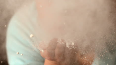 Woman-blowing-flour-from-hand
