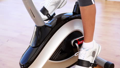 Fit-woman-working-out-on-exercise-bike