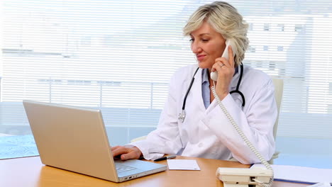 Blonde-doctor-working-at-her-desk