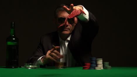 Cool-gambler-throwing-chips-at-camera