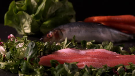 Fresh-trout-fillet-falling-on-a-bed-of-leaves