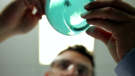 Low-angle-view-of-blue-beaker-of-chemicals