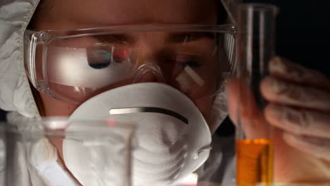 Scientist-inspecting-liquid-in-test-tube