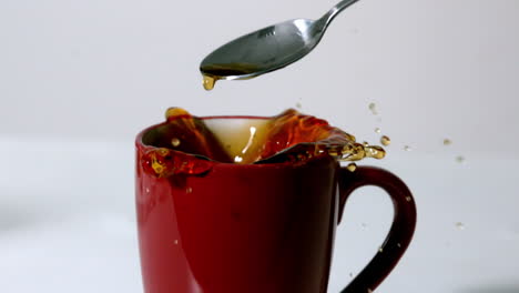 Teabag-falling-into-red-mug