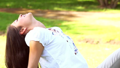 Pretty-girl-sitting-on-the-grass-smiling-at-camera