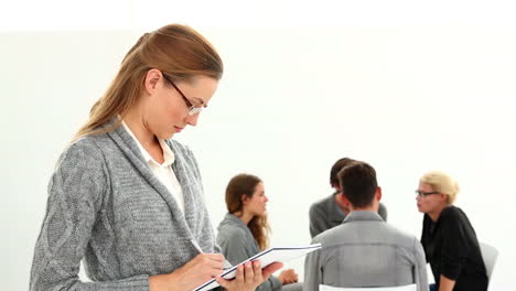 Rehab-group-sitting-in-a-circle-with-therapist-taking-notes