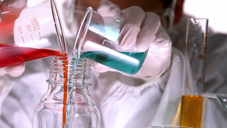 Scientist-mixing-and-pouring-liquids