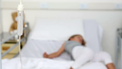Little-girl-lying-in-hospital-bed-with-an-iv-drip