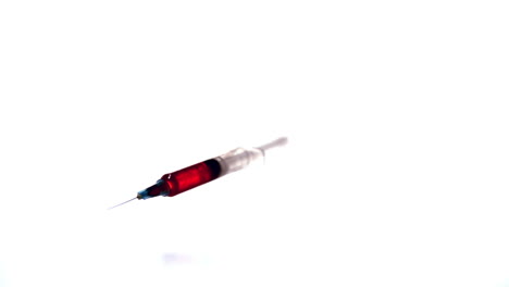 Syringe-with-red-liquid-falling