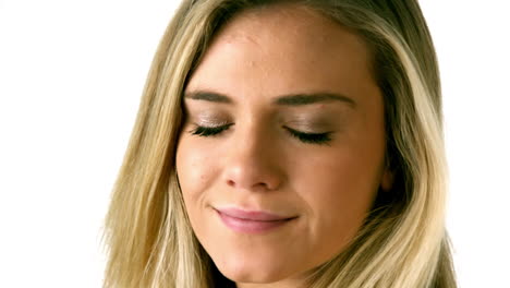 Pretty-blonde-smiling-at-camera-on-white-background