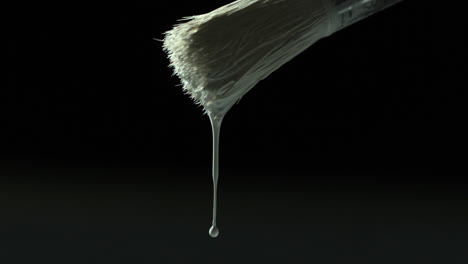 White-paint-dripping-from-paintbrush