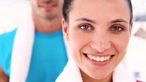 Fit-couple-smiling-at-camera