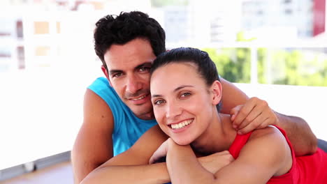 Fit-couple-smiling-at-camera
