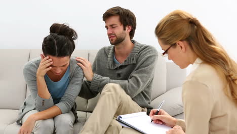 Young-unhappy-couple-talking-with-their-therapist