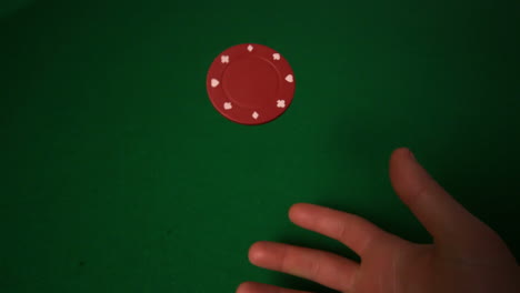 Hand-flipping-red-casino-chip