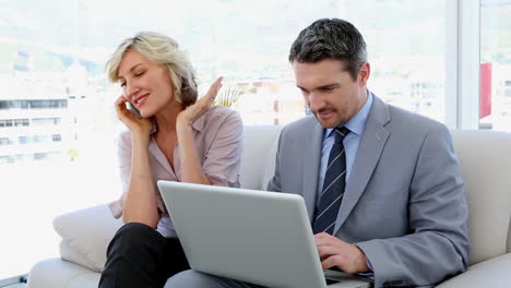 Business-people-working-together-on-laptop