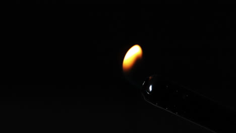 Large-flame-coming-from-lighter-on-black-background