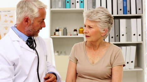 Doctor-listening-to-patients-chest-with-stethoscope