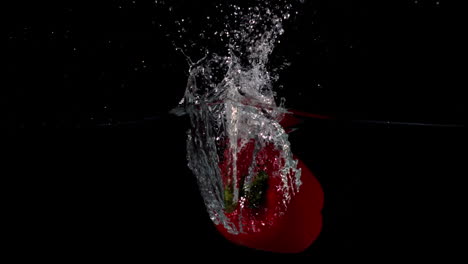 Red-pepper-falling-in-water-on-black-background