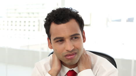 Frowning-handsome-businessman-having-neck-pain