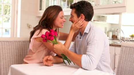 Happy-man-giving-his-partner-pink-roses