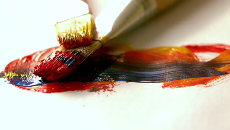 Paintbrushes-dropping-on-page-with-brushstrokes