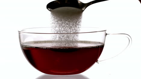 Teaspoon-pouring-sugar-into-cup-of-tea